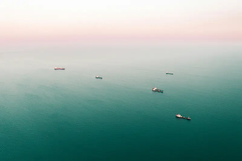 Ships at anchor in a hazy sea, seen from the air